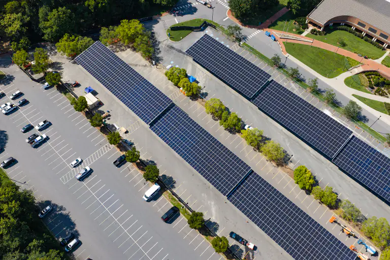Three diagonal solar canopy runs over a campus parking lot