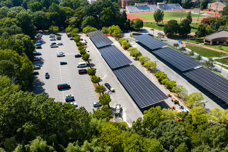 Solar carport canopies with the campus running track visible behind