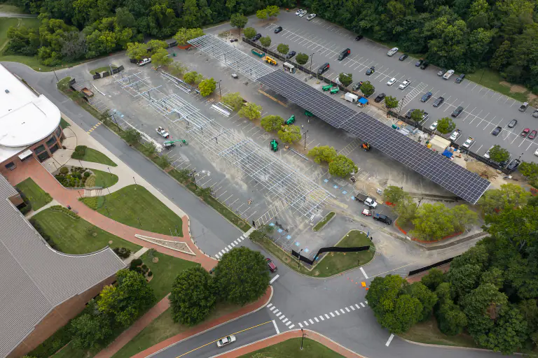 Aerial of the campus lots showing a completed canopy beside framework under construction